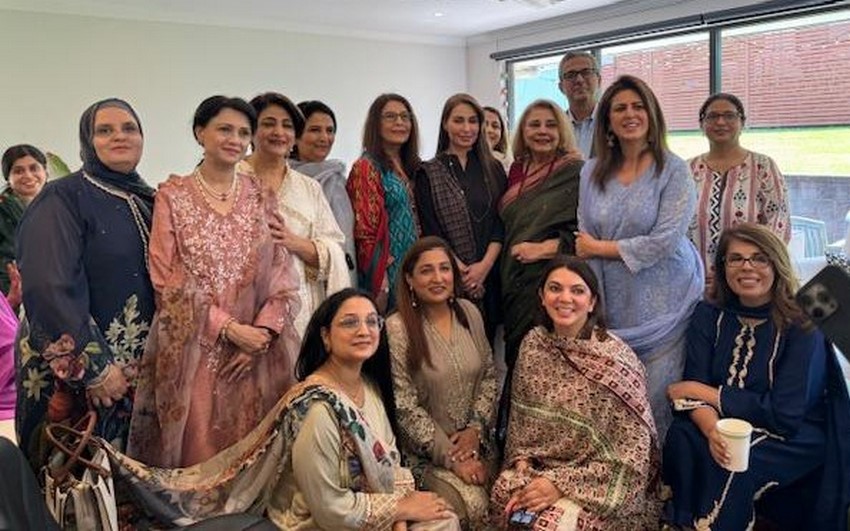 A group of women posing for a photo
Description automatically generated