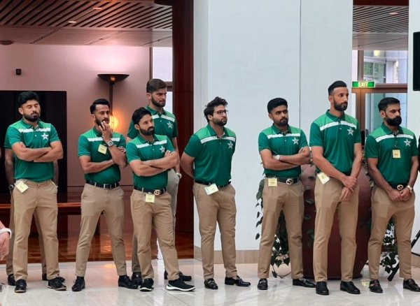 A group of men in green shirts
Description automatically generated