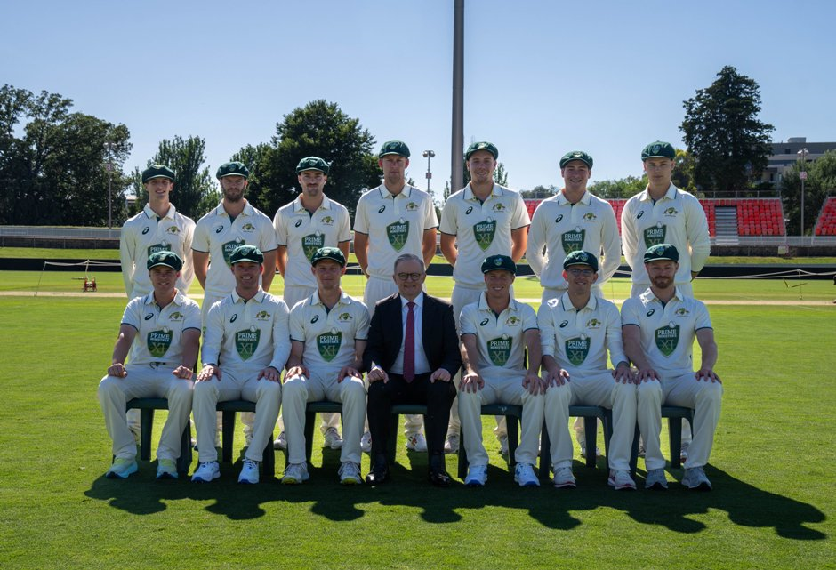 A group of men in white uniforms posing for a photo
Description automatically generated