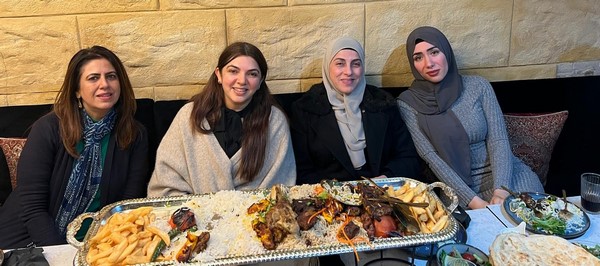 A group of women sitting at a table with food
Description automatically generated