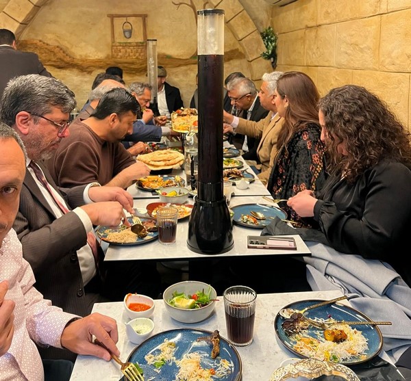 A group of people eating at a table
Description automatically generated