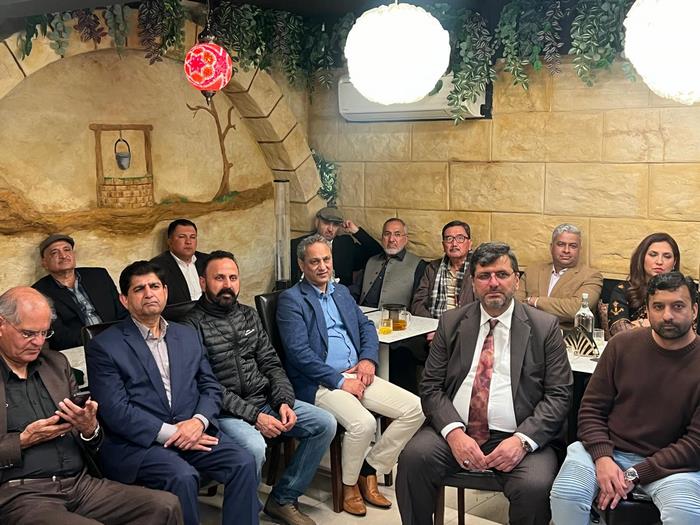 A group of men sitting in chairs
Description automatically generated