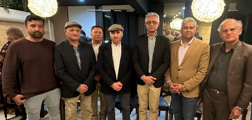 A group of men standing together
Description automatically generated
