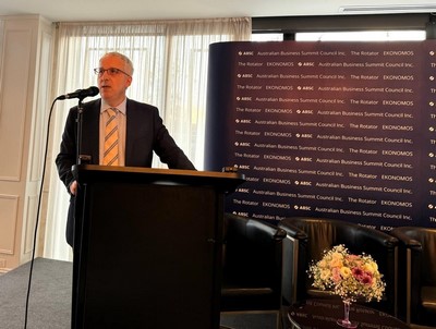 A person standing at a podium
Description automatically generated
