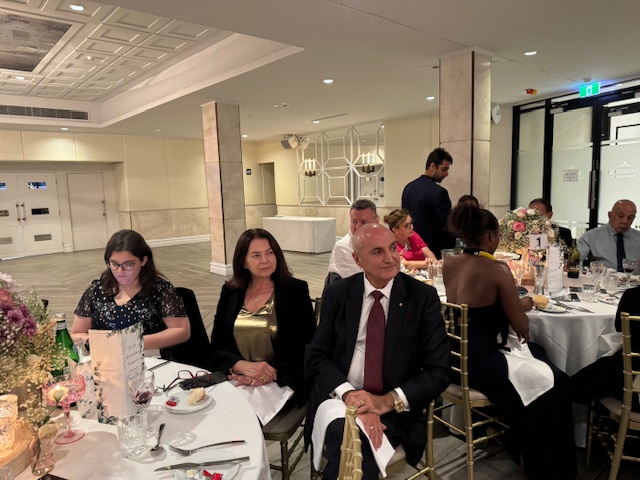 A group of people sitting at tables
Description automatically generated