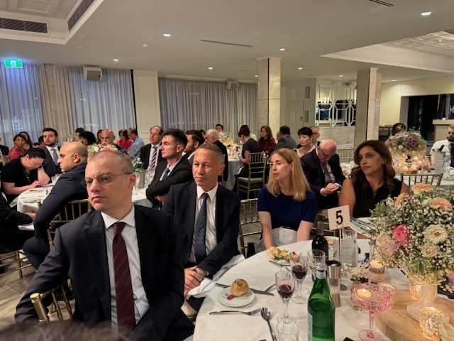 A group of people sitting at a table
Description automatically generated