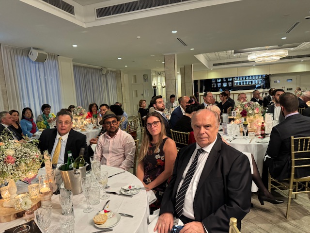 A group of people sitting at a table
Description automatically generated