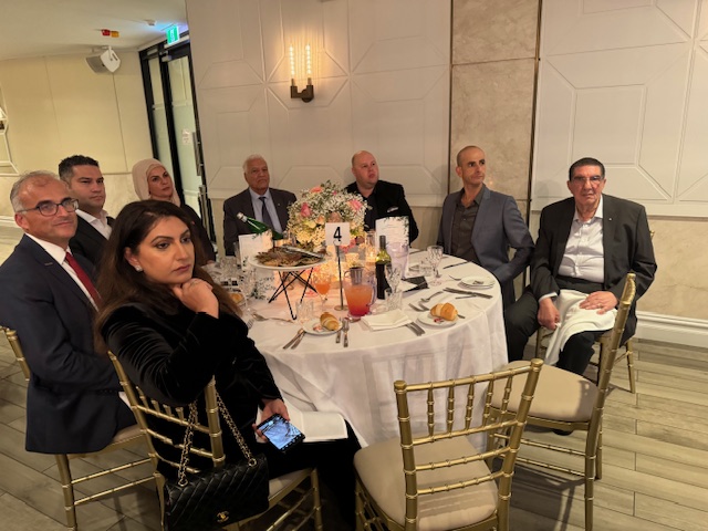 A group of people around a table
Description automatically generated