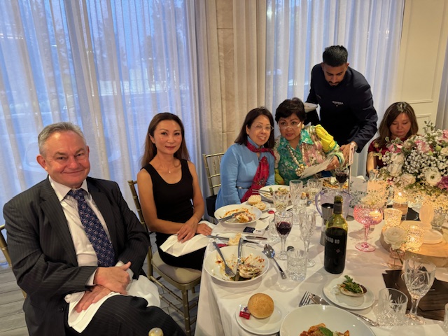 A group of people sitting at a table
Description automatically generated