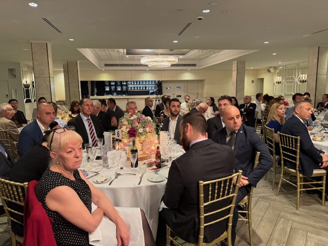 A group of people sitting at tables
Description automatically generated