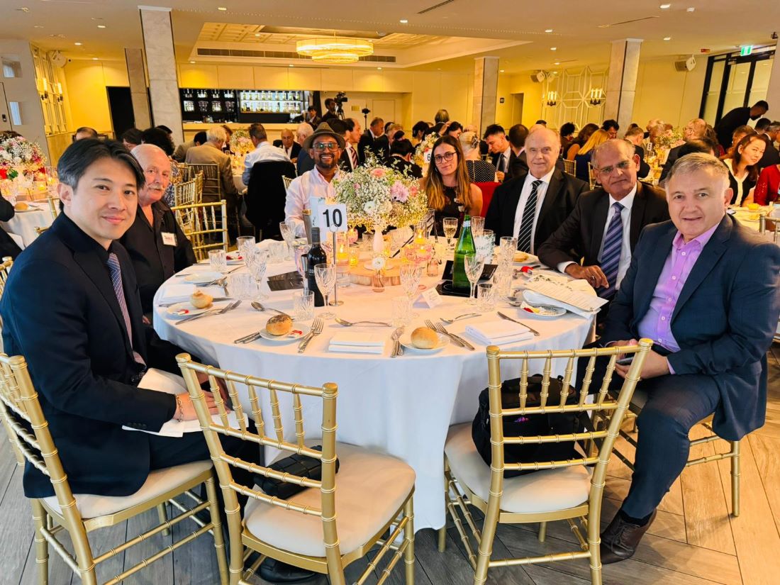 A group of people sitting at a table
Description automatically generated
