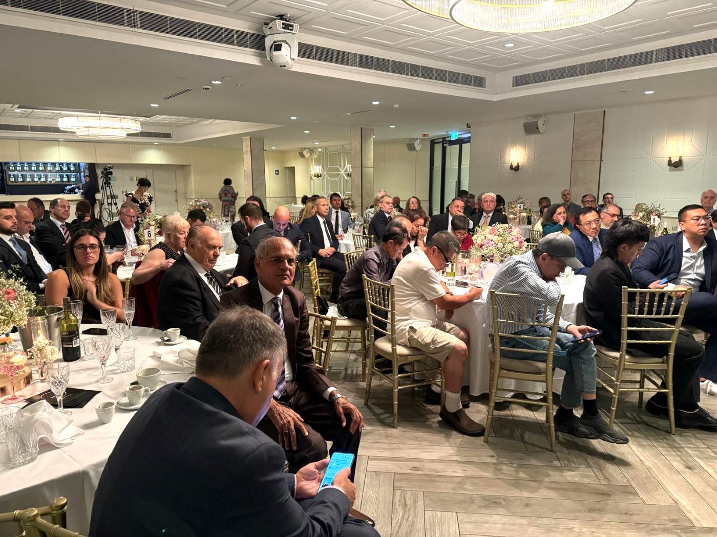 A group of people sitting at tables
Description automatically generated