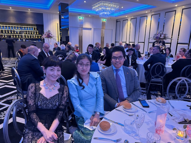 A group of people sitting at a table

Description automatically generated