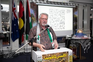 A person standing at a podium

Description automatically generated