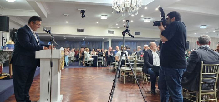A person taking a picture of a group of people

Description automatically generated