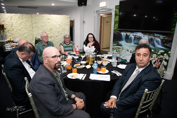 A group of people sitting around a table

Description automatically generated