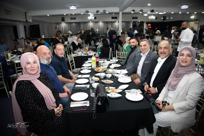 A group of people sitting at a table

Description automatically generated
