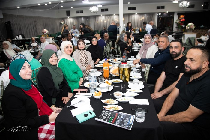 A group of people sitting at a table

Description automatically generated