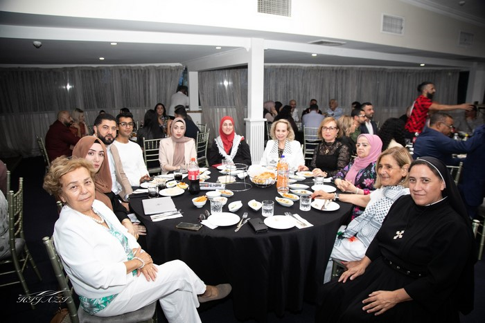 A group of people sitting around a table

Description automatically generated