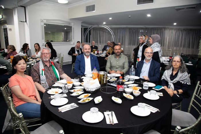 A group of people sitting around a table

Description automatically generated