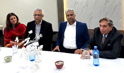 A group of people sitting at a table
Description automatically generated