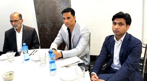 A group of men sitting at a table
Description automatically generated