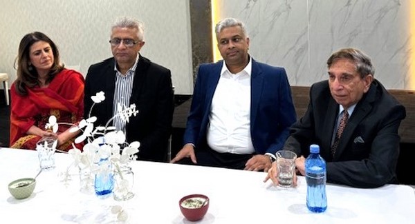 A group of men sitting at a table
Description automatically generated