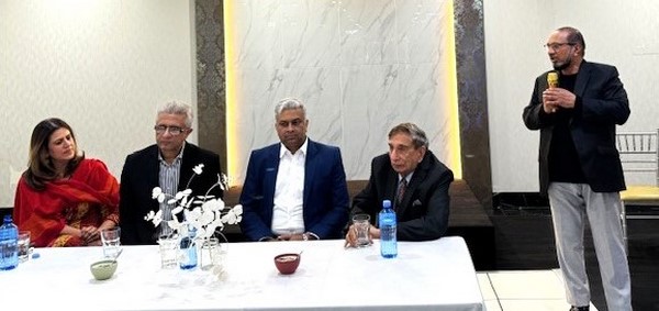 A group of men sitting at a table
Description automatically generated