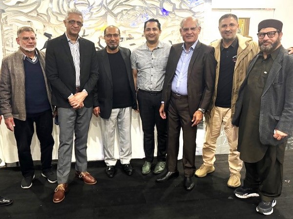 A group of men standing together
Description automatically generated