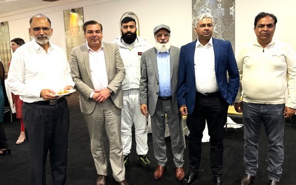 A group of men standing together
Description automatically generated