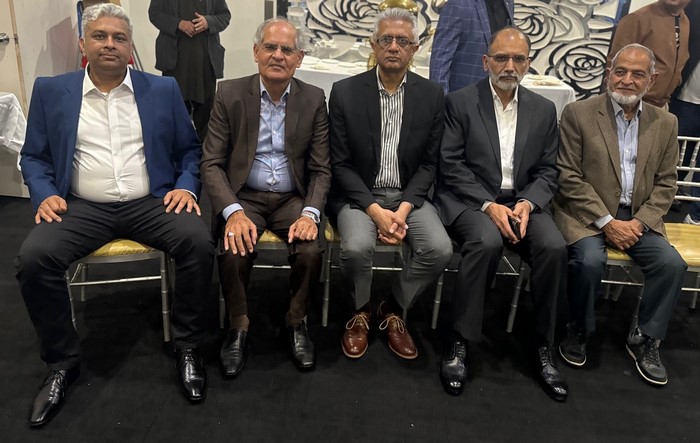 A group of men sitting in chairs
Description automatically generated