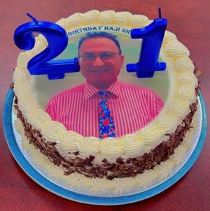 A cake with a picture of a person
Description automatically generated