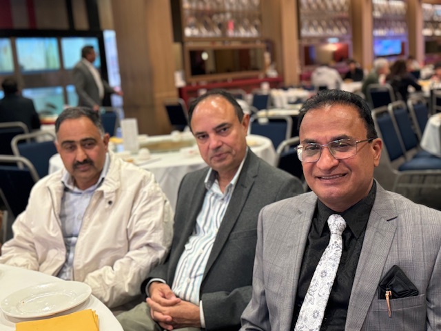 A group of men sitting at tables
Description automatically generated