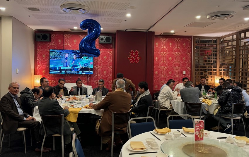 A group of people sitting at tables
Description automatically generated