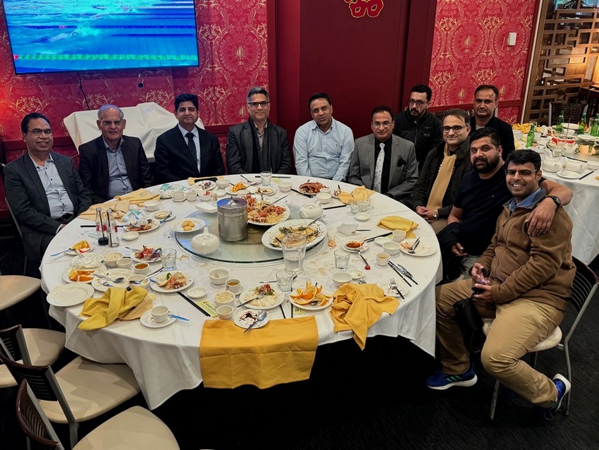 A group of people around a table
Description automatically generated
