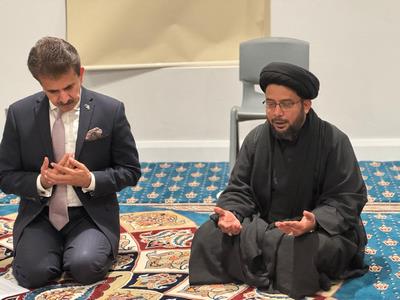 Two men in suits and robes on a rug
Description automatically generated