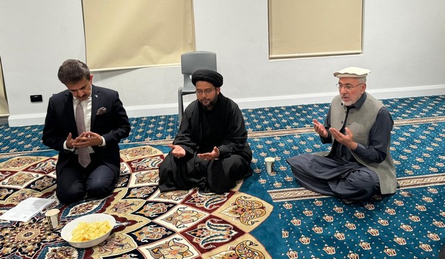 A group of men sitting on the floor
Description automatically generated