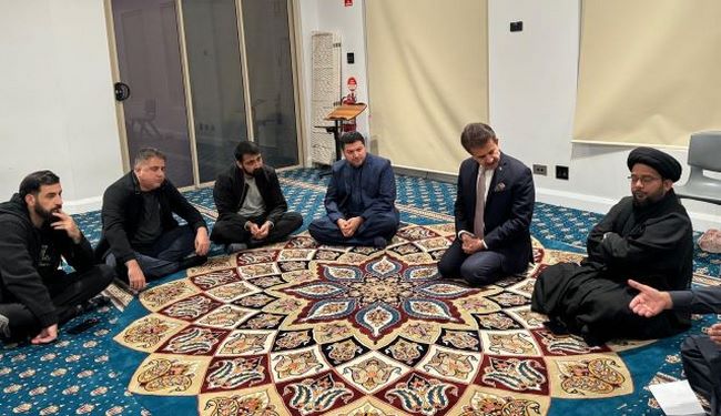 A group of men sitting on a rug
Description automatically generated