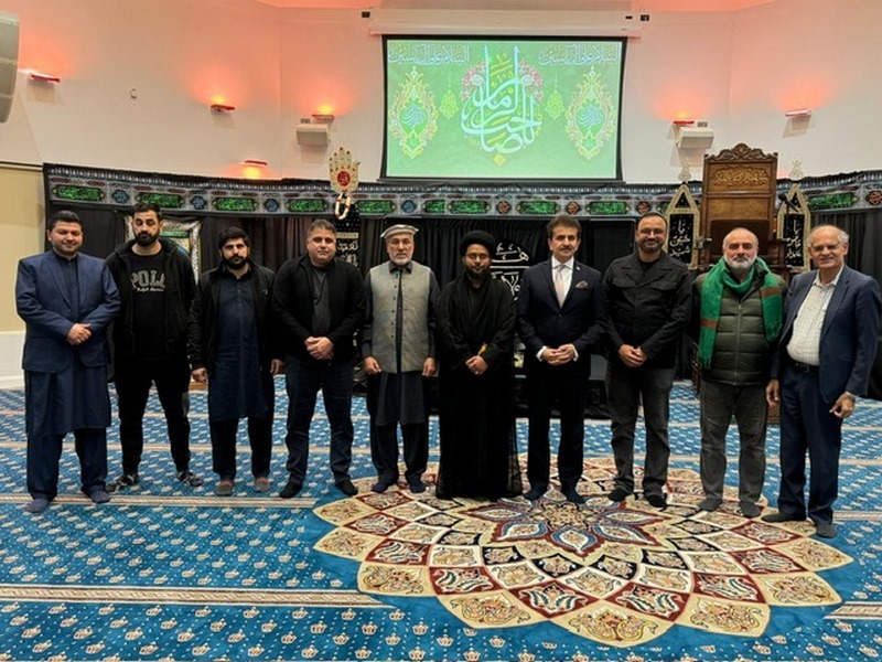 A group of men standing in a room
Description automatically generated