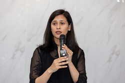 A person holding a microphone
Description automatically generated