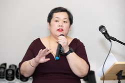 A person holding a microphone
Description automatically generated
