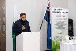 A person standing at a podium

Description automatically generated