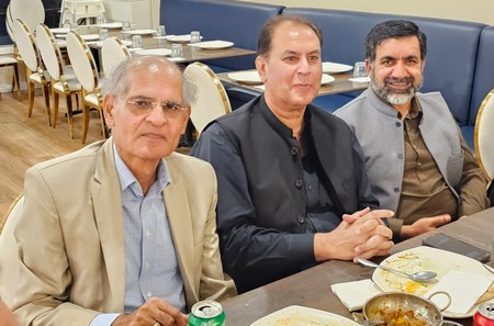 A group of men sitting at a table

Description automatically generated