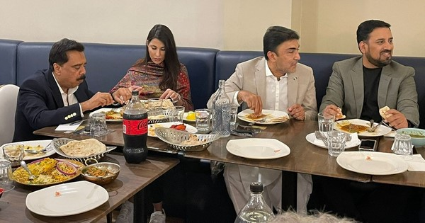 A group of people sitting at a table eating food

Description automatically generated