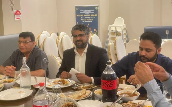 A group of men sitting at a table

Description automatically generated
