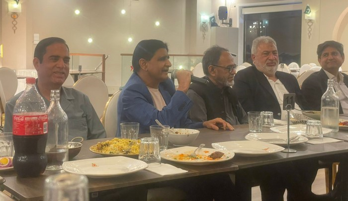 A group of people sitting at a table

Description automatically generated