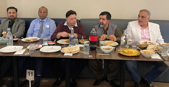A group of people sitting at a table

Description automatically generated