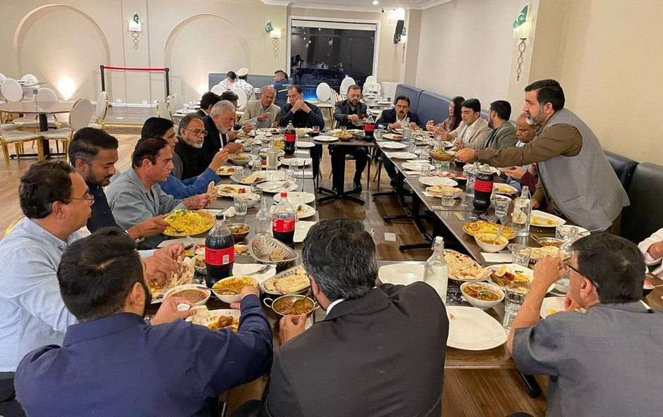 A group of people sitting at a table eating food

Description automatically generated