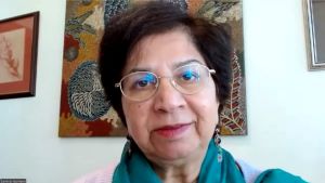 A person wearing glasses and a blue scarf
Description automatically generated