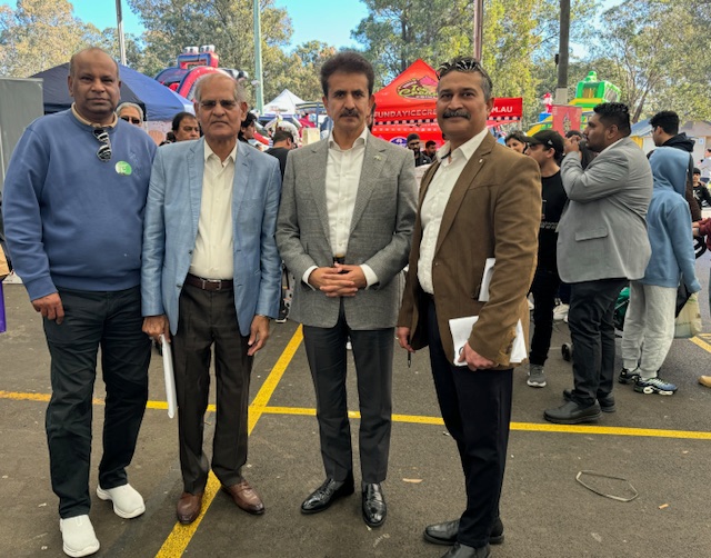 A group of men standing in a parking lot
Description automatically generated